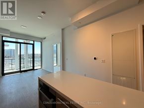 Toronto (Bayview Village) condo for rent - A spacious room with a large window and a door on the right side.