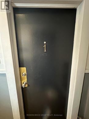 Ottawa triplex for rent - A black door with a gold handle and a number 1 on it.