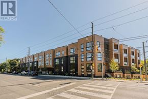 Toronto (Birchcliffe-Cliffside) townhouse for rent - A street view of a residential area with apartment buildings and a crosswalk.