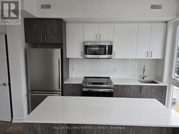 Toronto (Birchcliffe-Cliffside) townhouse for rent - A kitchen with a white counter top and stainless steel appliances.