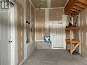 Barrie (Painswick South) apartment for rent - A room under construction with a white door and a wooden shelf.