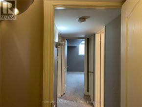 Barrie (Painswick South) apartment for rent - A hallway with a light on the ceiling and a door on the right.