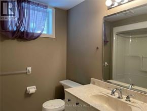 Barrie (Painswick South) apartment for rent - A bathroom with a sink, toilet, and mirror.