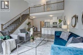 Barrie (Ardagh) apartment for rent - A living room with a glass coffee table and a staircase.