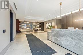 Kitchener condo for rent - A reception area with a marble counter and a grey rug.