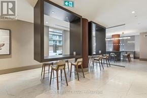 Kitchener condo for rent - A dining area with a table and chairs in a modern setting.