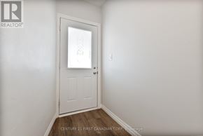 St. Thomas multi-family for rent - A white door in a room with a brokerage logo on the wall.