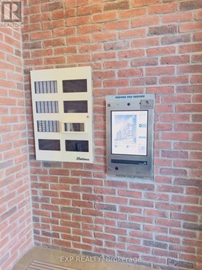 Toronto (Cliffcrest) condo for rent - A real estate brokerage sign is displayed on a brick wall.