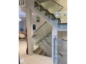 Vancouver apartment for rent - A staircase with a glass railing and a white wall.
