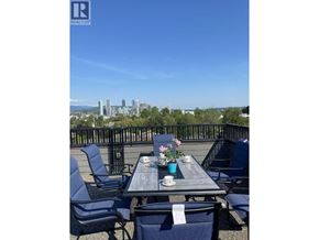 Vancouver apartment for rent - A table with chairs and a view of the city skyline in the background.