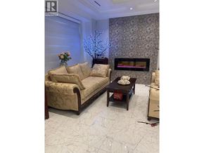 Vancouver apartment for rent - A living room with a couch, coffee table, and fireplace.