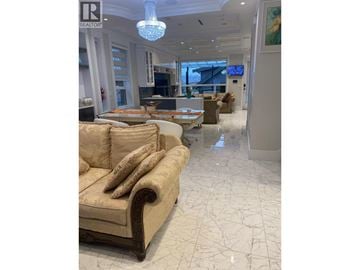 Vancouver apartment for rent - A living room with a beige sofa and a chandelier.