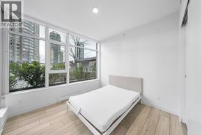 Burnaby apartment for rent - A bedroom with a large bed and a view of the city.
