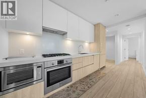 Burnaby apartment for rent - A modern kitchen with wooden cabinets and stainless steel appliances.