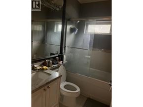 Richmond apartment for rent - A bathroom with a toilet, sink, and shower.
