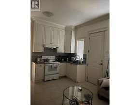 Richmond apartment for rent - A kitchen with a refrigerator, oven, and microwave.