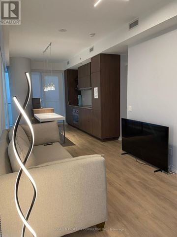 Toronto (Church-Yonge Corridor) condo for rent - A modern living room with a white couch and a television.