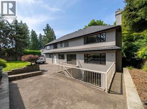 Vancouver apartment for rent - A house with a grey roof and a white car parked in front.