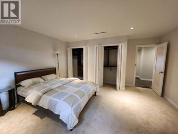 Vancouver apartment for rent - A bedroom with a large bed and a carpeted floor.