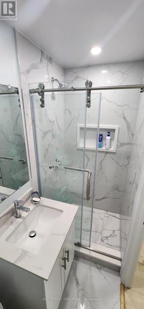Toronto (Bayview Woods-Steeles) apartment for rent - A bathroom with a marble wall and a walk-in shower.