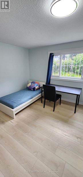 Toronto (Bayview Woods-Steeles) apartment for rent - A room with a bed, desk, and chair.