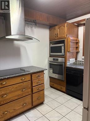 Richmond Hill (Crosby) apartment for rent - A kitchen with a black granite countertop and wooden cabinets.