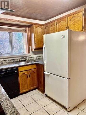Richmond Hill (Crosby) apartment for rent - A white refrigerator in a kitchen with wooden cabinets.