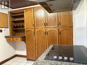Richmond Hill (Crosby) apartment for rent - A kitchen with wooden cabinets and a granite countertop.