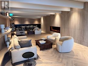 Vaughan (Vaughan Corporate Centre) condo for rent - A modern living room with a fireplace and comfortable seating.