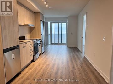 Vaughan (Vaughan Corporate Centre) condo for rent - A kitchen with wooden cabinets and a stainless steel refrigerator.