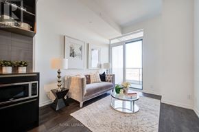 Vaughan (Concord) condo for rent - A modern living room with a couch, coffee table, and a large window.