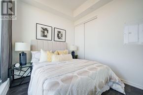 Vaughan (Concord) condo for rent - A bedroom with a large bed and two framed pictures on the wall.