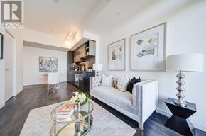 Vaughan (Concord) condo for rent - A living room with a white couch and a glass coffee table.