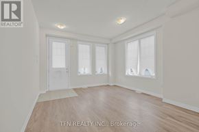 Wasaga Beach apartment for rent - A staircase with a wooden railing and grey carpeted steps.