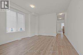 Wasaga Beach apartment for rent - A room with wooden flooring and a window with blinds.