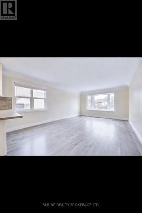 London East (East M) apartment for rent - A room with a window and a wooden floor.