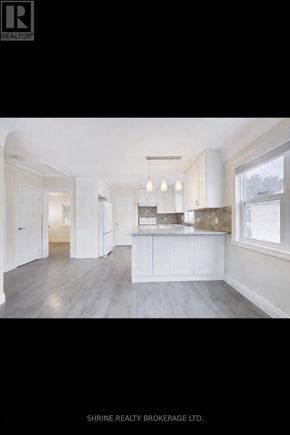 London East (East M) apartment for rent - A well-lit, spacious kitchen with white cabinetry and a large island.