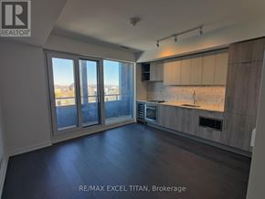 Toronto (Humewood-Cedarvale) condo for rent - A spacious kitchen with a view of the city through large windows.