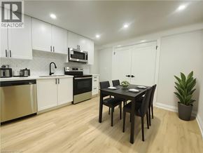 Hamilton apartment for rent - A kitchen with a table and chairs in the middle of the room.