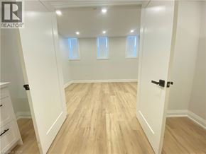 Hamilton apartment for rent - A room with wooden flooring and white walls.