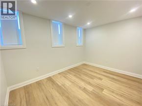 Hamilton apartment for rent - A room with wooden flooring and two windows.
