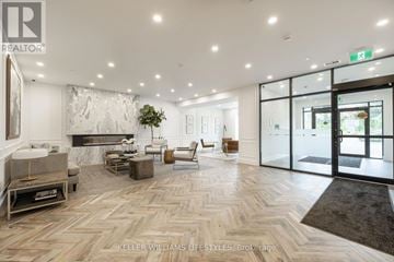 London North (North R) condo for rent - A spacious living room with a fireplace and a large painting on the wall.