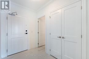 London North (North R) condo for rent - A white hallway with three doors and a brokerage logo.