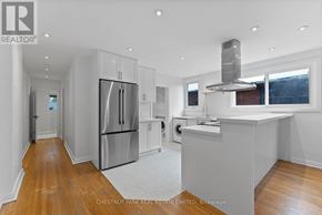 Toronto (Lawrence Park South) multi-family for rent - A modern kitchen with stainless steel appliances and wooden floors.