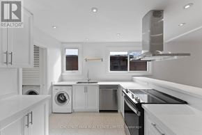 Toronto (Lawrence Park South) multi-family for rent - A modern kitchen with white cabinets and stainless steel appliances.