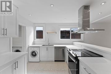 Toronto (Lawrence Park South) multi-family for rent - A modern kitchen with white cabinets and stainless steel appliances.