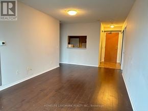 Toronto (Willowdale East) condo for rent - A room with wooden flooring and a door leading to another room.
