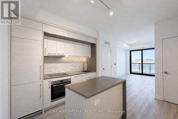 Toronto (Bayview Village) condo for rent - A modern kitchen with white cabinets and a large island.