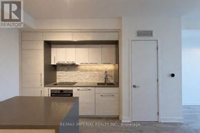 Toronto (Bayview Village) condo for rent - A modern kitchen with a countertop and cabinets.