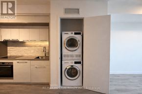 Toronto (Bayview Village) condo for rent - A washer and dryer are built into a wall in a modern kitchen.